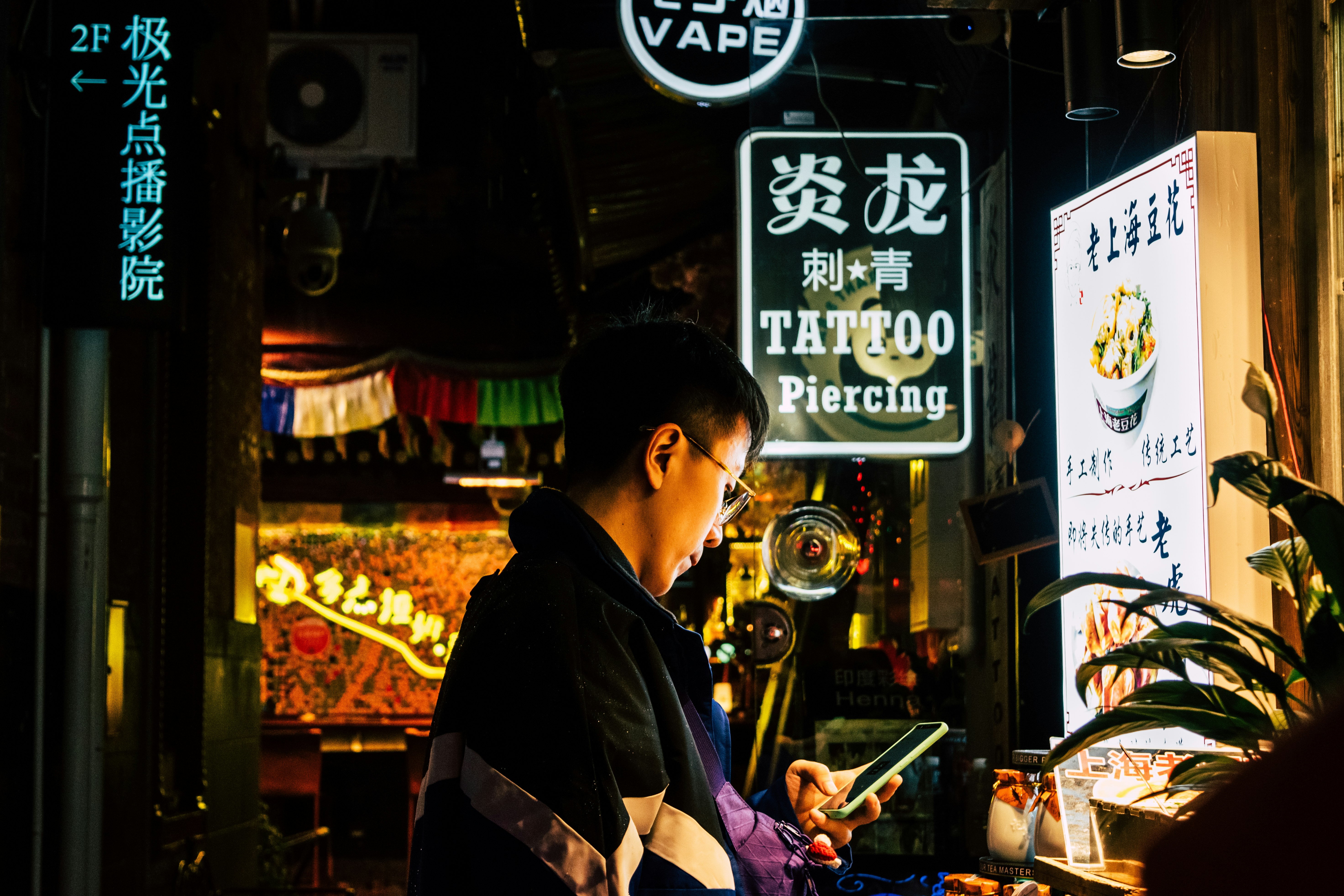 man in black jacket holding smartphone